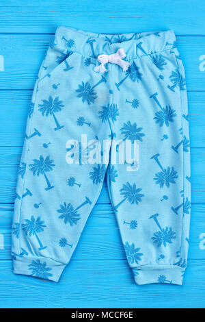Light blue summer baby leggings. Stylish patterned children trousers, front view. Fashionable kids pants on sale. Stock Photo