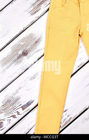Girls slim yellow cotton trousers. Female solid yellow pants on