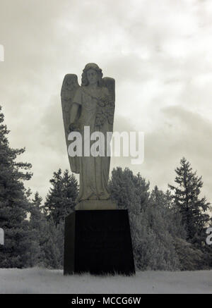 Statue of an angel on a pedestal at the Evergreen-Washelli cemetery in North Seattle, Washington. Infrared.