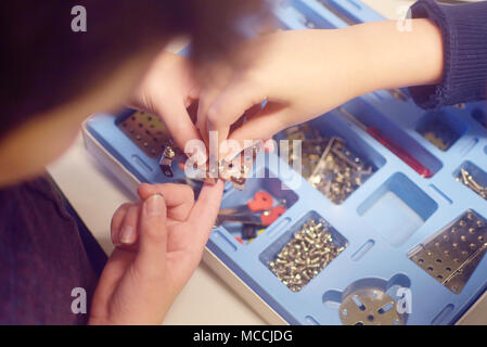 child tinkers children's set in a box of metal building kit for modeling, nuts, bolts, tools Stock Photo