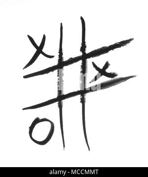 Tic-tac-toe game painted in black ink or made with a cosmetic product, eyeliner, on a white background Stock Photo