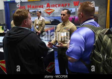 Maj. Salvador Jauregui, the Marine Operational Test Squadron One science and technology officer, answers aviation-related questions at the WEST 2018 in San Diego, Feb. 8. WEST 2018 allows innovators, industry leaders and the military the opportunity to network, learn and work together with the goal of meeting and overcoming challenges facing today's Sea Services. (U.S. Marine Corps photo by Sgt. David Bickel/Released) Stock Photo