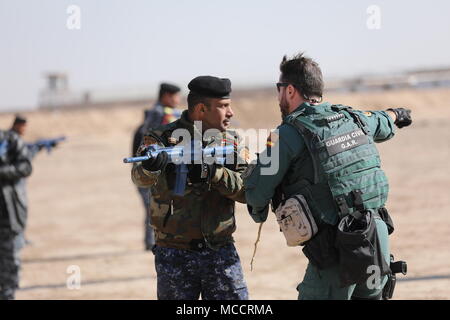 A Spanish Guardia Civil trainer instructs an Iraqi Federal Police member assigned to 3rd Battalion, 4th Brigade, during a class on urban warfare movement at the Besmaya Range Complex, Iraq, Feb. 8, 2018.  Since 2014, Operation Inherent Resolve members have built baseline capacity of more than 130,000 Iraqi security forces trained to defeat ISIS within the Iraqi Security Forces, it is time to enhance those capabilities to prevent resurgence of ISIS and create stability within their nation. (U.S. Army photo by Master Sgt. Horace Murray) Stock Photo