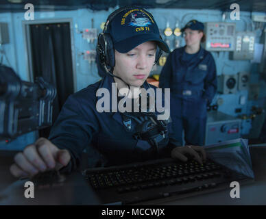 180212-N-MJ135-2013 ARABIAN GULF (Feb. 12, 2018) Seaman Autumn Swartz uses a radar on the bridge of the aircraft carrier USS Theodore Roosevelt (CVN 71). Theodore Roosevelt and its carrier strike group are deployed to the U.S. 5th Fleet area of operations in support of maritime security operations to reassure allies and partners and preserve the freedom of navigation and the free flow of commerce in the region. (U.S. Navy photo by Mass Communication Specialist 3rd Class Spencer Roberts/Released) Stock Photo