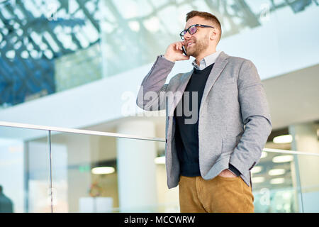 Bearded Manager Using Smartphone Stock Photo