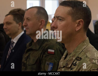 The leaders of Battle Group Poland and local community leaders listen to Andrea Bekić, the Croatian Ambassador to Poland, speak as she expresses gratitude to Polish leaders and shares Croatian culture during a Croatian cultural celebration at the Polish 15th Mechanized Brigade headquarters, Poland, Feb. 12, 2018. The unique, multinational battle group is comprised of U.S., U.K., Croatian and Romanian soldiers serve with the Polish 15th Mechanized Brigade as a deterrence force in northeast Poland in support of NATO’s Enhanced Forward Presence. (U.S. Army photo by Spc. Andrew McNeil/ 22nd Mobile Stock Photo