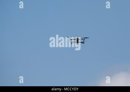 Eye level picture of drone with camera in a blue sky Stock Photo