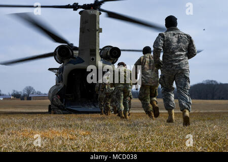 Soldiers with the 101st Combat Aviation Brigade, 101st Airborne Division (Air Assault) load equipment into a CH-47 Chinook helicopter in preparation to jump their tactical operations center (TOC) to a new location during Warfighter, a two-week command and control exercise February 13, 2017 at Ft. Campbell, Ky. (U.S. Army photo taken by Sgt. Marcus Floyd, 101st Combat Aviation Brigade) Stock Photo