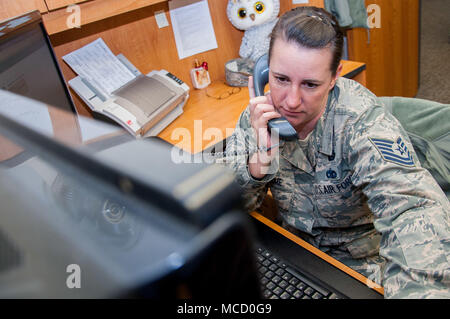 Academic Coding Branch is a United States Air Force personnel section tasked with maintaining officer academic credentials within the Air Force Military Personnel Data System. As noncommissioned officer-in-charge, branch leadership provides direct assistance to officers updating official education records supporting approximately 130,000 total force members. The archival image records telephone support operations in a personnel office setting. Stock Photo