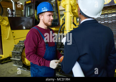 Having Discussion at Spacious Warehouse Stock Photo