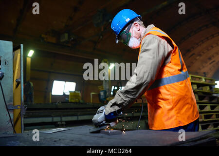 Highly Professional Worker Using Angle Grinder Stock Photo