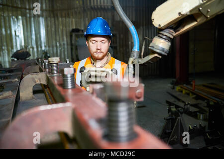 Machine Operator Wrapped up in Work Stock Photo