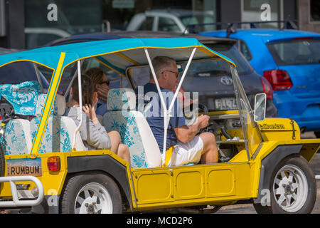 Yellow Mini Moke car vehicle in Sydney Australia carrying a family Stock Photo