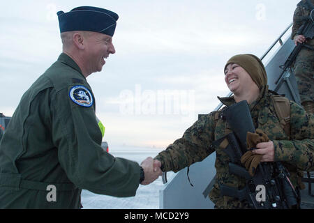 Air Force Col. Mark Schmidt, director of operations for Alaskan Command, greets visiting U.S. Marines with the Special Purpose Marine-Air-Ground Task Force-Arctic Edge 18 as they arrive at Joint Base Elmendorf-Richardson, Alaska, Feb. 13, 2018. The Marines are at JBER to support Arctic Edge 2018, a biennial, large-scale, joint-training exercise that prepares and tests the U.S. military’s ability to operate tactically in the extreme cold-weather conditions found in Arctic environments. Under the authority of the North American Aerospace Defense and U.S. Northern Command, more than 1500 particip Stock Photo