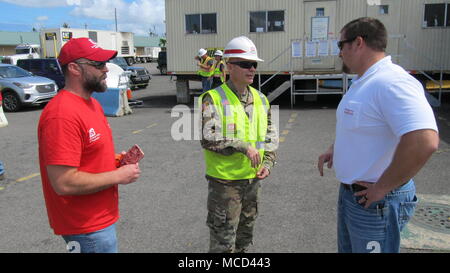 U.S. Army Corps of Engineers, Tulsa District Commander Col. Chris Hussin discusses temporary emergency power with Mission Manager Travis Miller (left) and Mission Liaison Jake Ellison at the Incident Support Base, Fort Buchanan, San Juan, Puerto Rico, February 16, 2018. Stock Photo