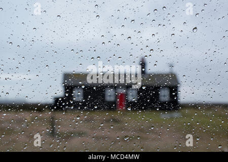 Cottage on Dungeness on Romney Marsh, Kent, UK taken during the rain through a car window. Stock Photo