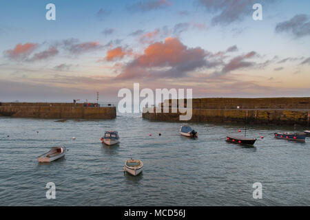 Mousehole Harbour, Cornwall, UK. 15th April 2018. UK Weather. After a rainy day, the weather finally cleared up at sunset this evening, giving a colourful end to the day at Mousehole. Credit: Simon Maycock/Alamy Live News Stock Photo