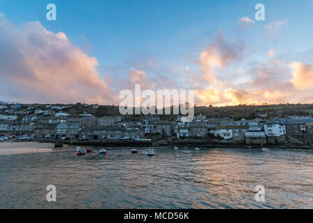 Mousehole Harbour, Cornwall, UK. 15th April 2018. UK Weather. After a rainy day, the weather finally cleared up at sunset this evening, giving a colourful end to the day at Mousehole. Credit: Simon Maycock/Alamy Live News Stock Photo