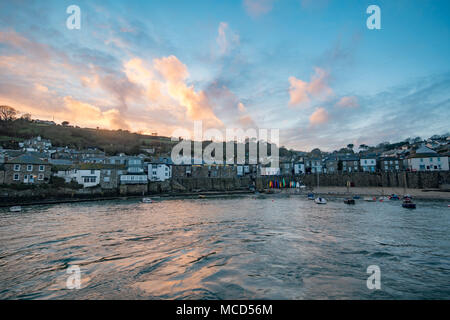 Mousehole Harbour, Cornwall, UK. 15th April 2018. UK Weather. After a rainy day, the weather finally cleared up at sunset this evening, giving a colourful end to the day at Mousehole. Credit: Simon Maycock/Alamy Live News Stock Photo