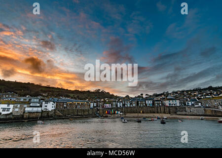 Mousehole Harbour, Cornwall, UK. 15th April 2018. UK Weather. After a rainy day, the weather finally cleared up at sunset this evening, giving a colourful end to the day at Mousehole. Credit: Simon Maycock/Alamy Live News Stock Photo