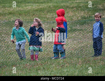 Leesburg, USA. 15th April 2018. UNITED STATES: April 15, 2018: Even with wind, cold and rain these kids played and had fun while watching the horses race at the 52nd Annual Loudoun Hunt Point to Point races at Oatlands Plantation near Leesburg. (Photo by Douglas Graham/Loudoun Now) Stock Photo