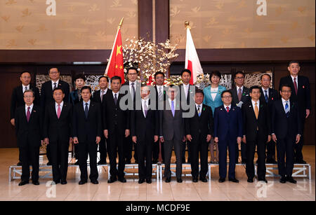 Tokyo, Japan. 16th Apr, 2018. Chinese State Councilor and Foreign Minister Wang Yi and Japanese Foreign Minister Taro Kono pose for group photos during the high-level economic dialogue between China and Japan in Tokyo, Japan, on April 16, 2018. Wang Yi on Monday co-chaired the fourth high-level economic dialogue with Taro Kono here. Credit: Ma Ping/Xinhua/Alamy Live News Stock Photo