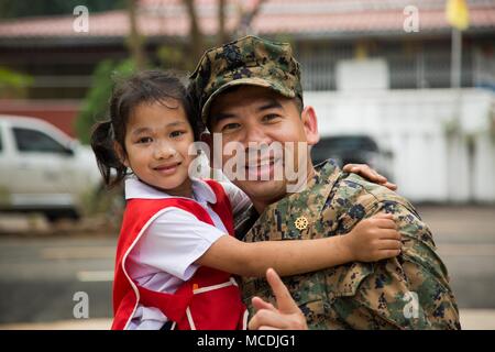 U.S. Navy Lt. Aroon Seeda shares smiles with a student during Exercise Cobra Gold 2018 at Pong Ka Sang School in Nakhon Ratchasima, Kingdom of Thailand, Feb. 20, 2018. Chaplain Seeda was Born and raised in Pluak Daeng, Rayong province, Kingdom of Thailand as a Buddhist monk and immigrated to the United States in 2001 before joining the Navy Reserve in 2008. Humanitarian civic assistance projects conducted during the exercise support the needs and humanitarian interests of the Thai people. Cobra Gold 18 is an annual exercise conducted in the Kingdom of Thailand and runs from Feb. 13-23 with sev Stock Photo