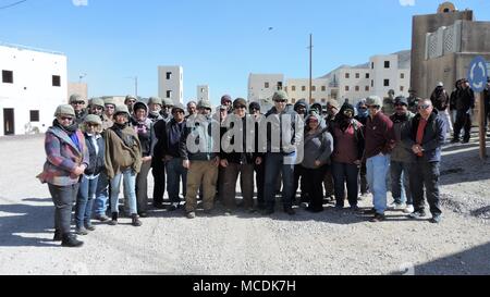 Members of the Killeen and Harker Heights Chamber of Commerce take a group photo with the civilian role players in support of the National Training Center at Fort Irwin, Calif., Feb. 18, 2018. The Killeen and Harker Heights Chambers of Commerce NTC visit is designed to strengthen relationships between civic leaders in the surrounding Fort Hood community and service members assigned to Fort Hood, Texas. (US Army photo by Maj. Anthony Clas, 7th Mobile Public Affairs Detachment) Stock Photo