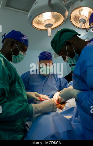 Medical Readiness Training Exercise (MEDRETE) is a multinational medical cooperation program. The archival image documents U.S. and Senegalese military medical personnel conducting a thyroid removal procedure at Hopital de la Paix in Ziguinchor, Senegal on February 14, 2018. Stock Photo