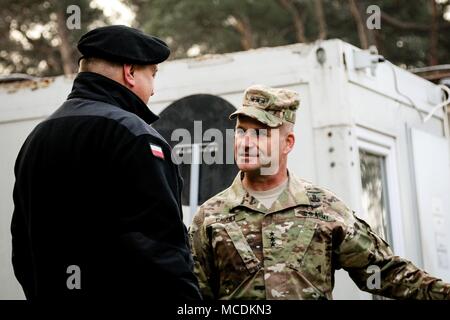 Polish Gen. Stanislaw Czosnek (left), commander of the Polish 11th Armored Cavalry Division, and Lt. Gen. Christopher Cavoli (right), commander of U.S. Army Europe, greet each other during Cavoli’s visit to 2nd Armored Brigade Combat Team, 1st Infantry Division in Zagan, Poland on Feb. 21, 2018. (U.S. Army photo by Spc. Hubert D. Delany III / 22nd Mobile Public Affairs Detachment) Stock Photo