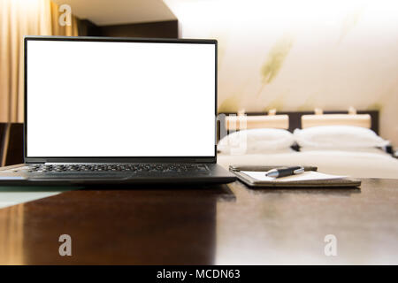 Laptop in hotel bedroom Stock Photo