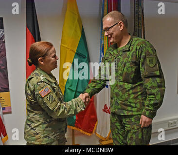Lithuanian Army Land Forces Major Arturas Seniut presented Command Sgt. Maj. Sheryl D. Lyon, former U.S. Army Europe senior enlisted leader, with the Divisions of the Lithuanian Armed Forces Medal of Distinction, Feb. 22 in an award ceremony on Clay Kaserne in Wiesbaden, Germany. Lyon was recognized for her exceptional distinction in enhancing the Lithuanian Armed Forces, professionalism and significant personal dedication to development of international military cooperation between the United States Army and the Land Forces of the Lithuanian Armed Forces. Stock Photo