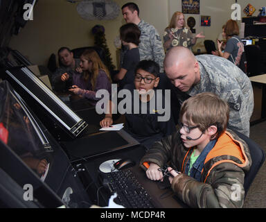 Staff Sgt. Travis Patterson, 334th Training Squadron instructor, briefs Biloxi school students on air traffic control radar simulator capabilities during Biloxi Career Exploration Day at Cody Hall Feb. 14, 2018, on Keesler Air Force Base, Mississippi. The school-aged children also toured the Trainer Development Center, 335th TRS and the Keesler Fire Department. (U.S. Air Force photo by Kemberly Groue) Stock Photo
