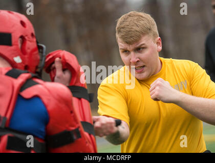 Information System Technician Seaman Phelan Payne fights a member of the ASF Academy while completing the OC course (oleoresin capsicum) Feb. 23 at Naval Support Activity Bethesda. After being sprayed, students go through multiple physical challenges to complete the capstone event for the Auxiliary Security Forces Academy. (U.S. Navy photo by Mass Communication Specialist 2nd Class William Phillips/Released) Stock Photo