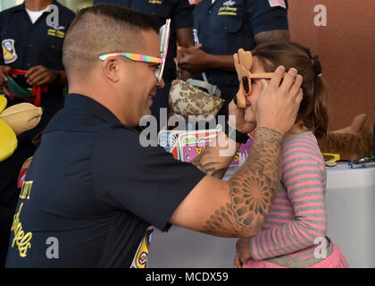 180225-N-ZC358-014  EL CENTRO, Calif. (Feb. 25, 2018) Aviation Structural Mechanic 1st Class, Jeff Cmar, interacts with a young fan at El Centro Regional Medical Hospital during a meet and greet event. The Blue Angels are scheduled to perform more than 60 demonstrations at more than 30 locations across the U.S. in 2018. (U.S. Navy photo by Mass Communication Specialist 2nd Class Jess Gray/Released) Stock Photo
