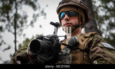 Staff Sgt. James Cason, aerial combat broadcaster, 1st Combat Camera Squadron, Joint Base Charleston, South Carolina, prepares for tactical drills Feb. 13, 2018, at McCrady Training Center, Eastover, S.C., during Scorpion Lens, an annual Ability to Survive and Operate training exercise mandated by Air Force Combat Camera job qualification standards. Held at the United States Army Training Center Fort Jackson, S.C., and the McCrady Training Center, Eastover, S.C., the exercise's purpose is to provide refresher training to combat camera personnel. Individuals are instructed in the areas of comba Stock Photo