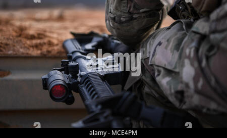 Staff Sgt. James Cason, aerial combat broadcaster, 1st Combat Camera Squadron, Joint Base Charleston, South Carolina, grounds his gear after tactical drills Feb. 8, 2018, at McCrady Training Center, Eastover, South Carolina, during Scorpion Lens, an annual Ability to Survive and Operate training exercise mandated by Air Force Combat Camera job qualification standards. Held at the United States Army Training Center Fort Jackson, South Carolina, and the McCrady Training Center, Eastover, South Carolina, the exercise's purpose is to provide refresher training to combat camera personnel. Individua Stock Photo