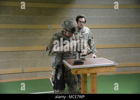 U.S. Army Spc. Jacqueline Delgado, assigned to U.S. Army Garrison Benelux, reassembles her M9 pistol during the Best Warrior Competition, in Chièvres Air Base, Belgium, Feb.22, 2018. (U.S. Army photo by Visual Information Specialist Pascal Demeuldre) Stock Photo