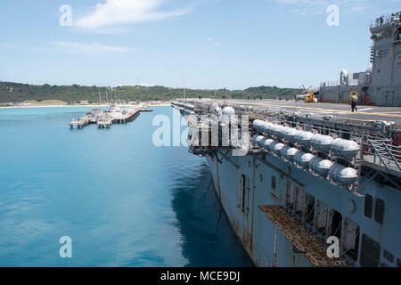 180409-N-XK809-354 WHITE BEACH, Okinawa (April 9, 2018) The amphibious assault ship USS Bonhomme Richard (LHD 6) arrives at White Beach Naval Facility for a scheduled port visit. Bonhomme Richard is in Okinawa as a final visit after six years of being forward-deployed to Japan and to host Okinawa citizens for ship tours during White Beach Festival 2018. The White Beach Festival is jointly hosted by Commander, Fleet Activities Okinawa (CFAO) and Japanese Maritime Self Defense Force, Sub-Area Activity Okinawa (SAAO) to reciprocate the hospitality the Okinawa community extends to U.S. forces stat Stock Photo