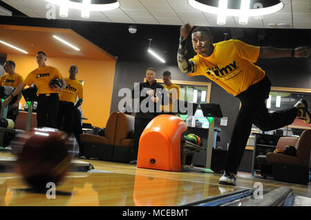 Sgt. Gavin E. Wainright Jr., from Fort Hood, Texas, launches the ball toward the pins during the All Army Bowling Trials Camp at Fort Lee’s TenStrike Bowling Center April 11. He is one of 11 male bowlers vying for four spots on the Army team that will compete against the Navy and Air Force in the Armed Forces Championship set for April 13-15 at the same location. The Navy and Air Force trial camps are being held concurrently. The state-of-the-art TenStrike is the Army's newest bowling facility. For updates on the sports competition, visit www.facebook.com/ArmedForcesSports. Stock Photo