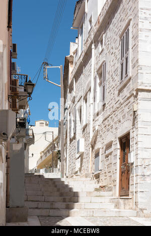 Narrow stone street with trees on the walls leading to Ano Syros island, Cyclades , Greece Stock Photo