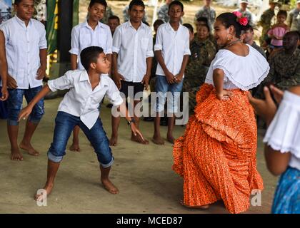 Children from a local school in Meteti, Panama, perform a dance for guests at the opening ceremony for Exercise New Horizons 2018, April 11, 2018. Representatives from the Ministry of Education, Ministry of Health, Ministry of Security, the government of Panama, the mayor of Meteti, and the commander of the 346th Air Expeditionary Group who the exercise falls under, Col. Darren Ewing, took part in the ceremony which was attended by about 150 community members. The joint-service exercise will provide deployment readiness training to U.S. military members, while also benefiting local communities Stock Photo