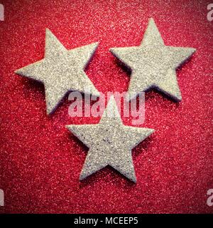 large silver stars on red illuminated background Stock Photo