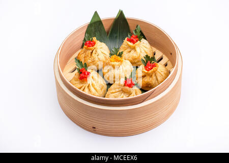 Baozi or munsun, or simply bao - a popular Chinese dish, which is a small pie, steamed. Isolated. Stock Photo