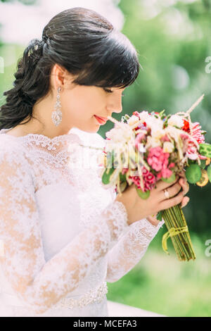 Portrait of girl smelling flowers, side view Stock Photo - Alamy