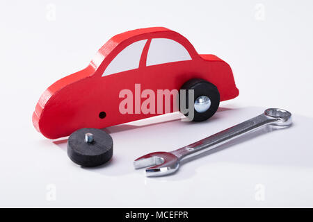 Elevated View Of Red Car And Wrench Isolated On White Background Stock Photo