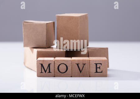 Close-up Of Move Text On Wooden Blocks In Front Of Cardboard Boxes Stock Photo