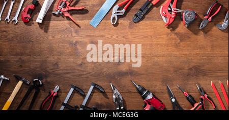 High Angle View Of Various Worktools In A Row On Wooden Desk Stock Photo