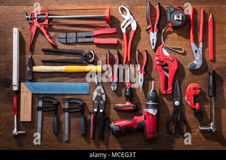 Elevated View Of Various Worktools On Wooden Desk Stock Photo