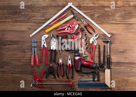 Elevated View Of Various Worktools On Wooden Desk Stock Photo